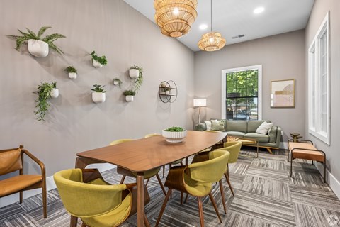 A dining room with a wooden table surrounded by yellow chairs.