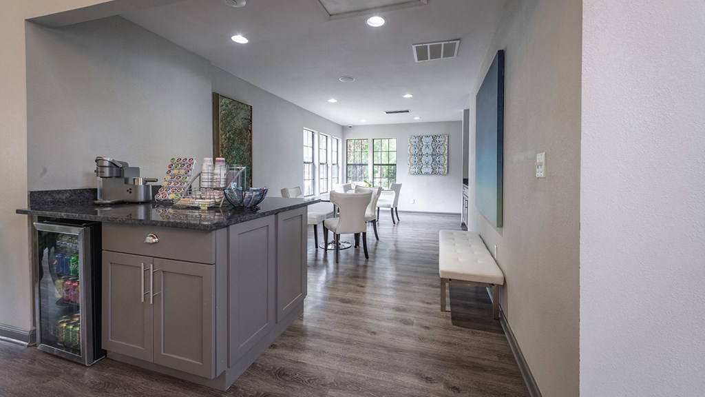 a coffee station with a counter and a seating area in the background