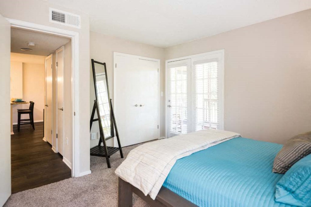 a bedroom with a bed and a mirror