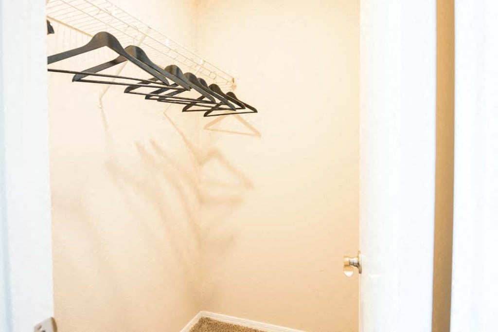 a closet with some clothes hangers on the wall