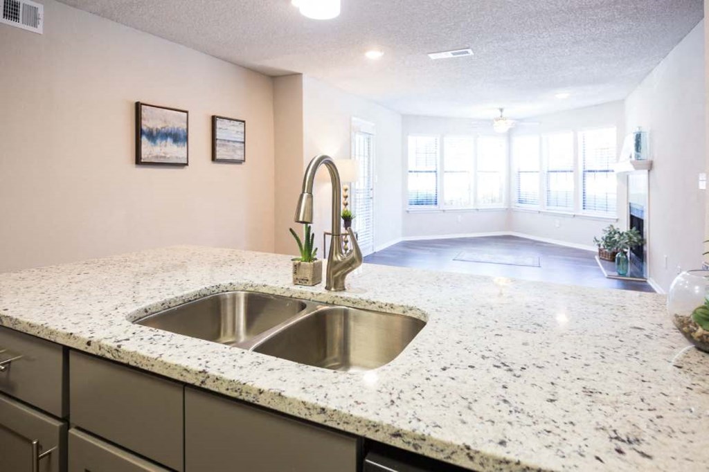 Kitchen Sink with living room in the background at Eclipse Apartments in Duluth