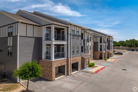 A row of modern townhouses with a clear blue sky above.