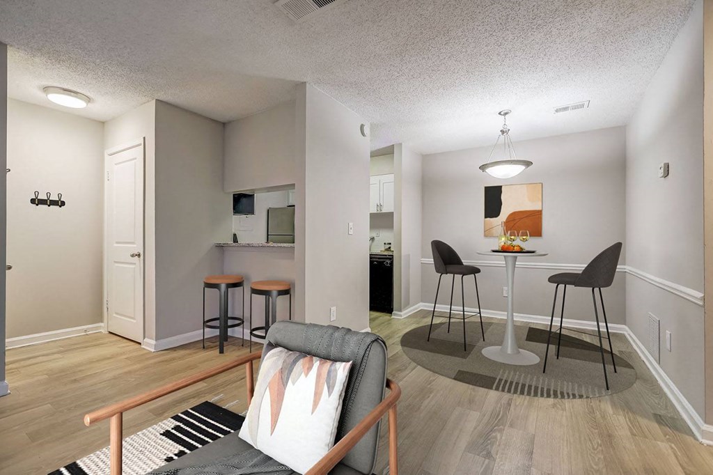 a living room and kitchen with a bar and a couch