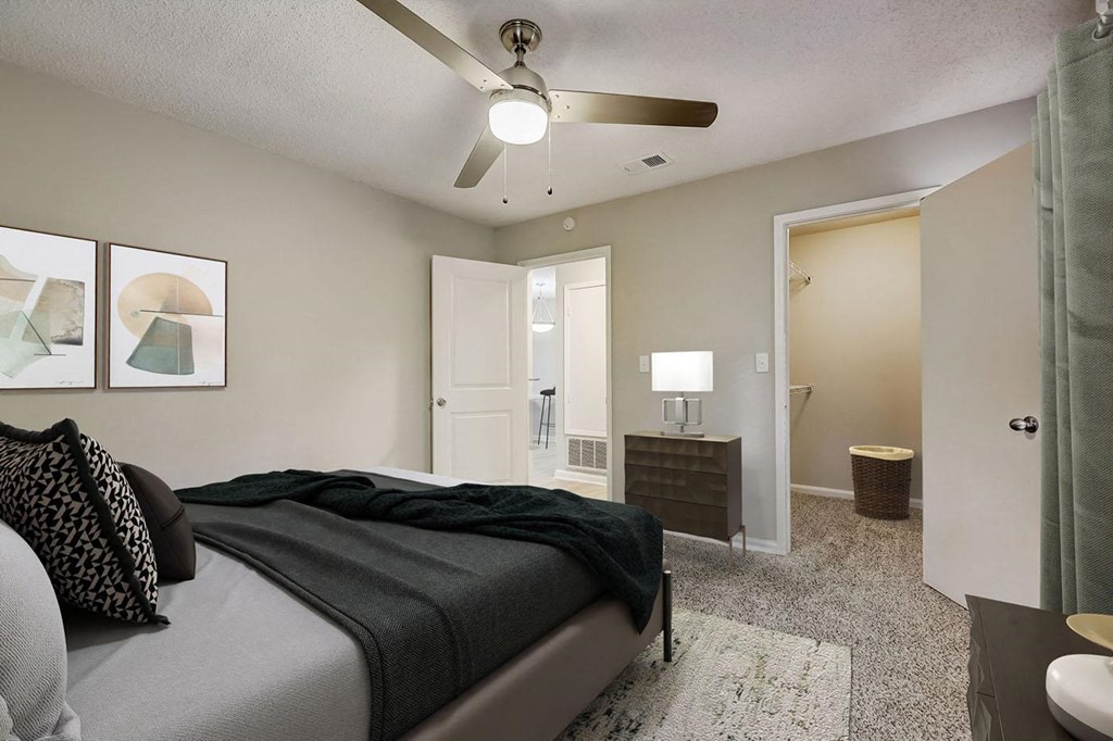a bedroom with a bed and a ceiling fan