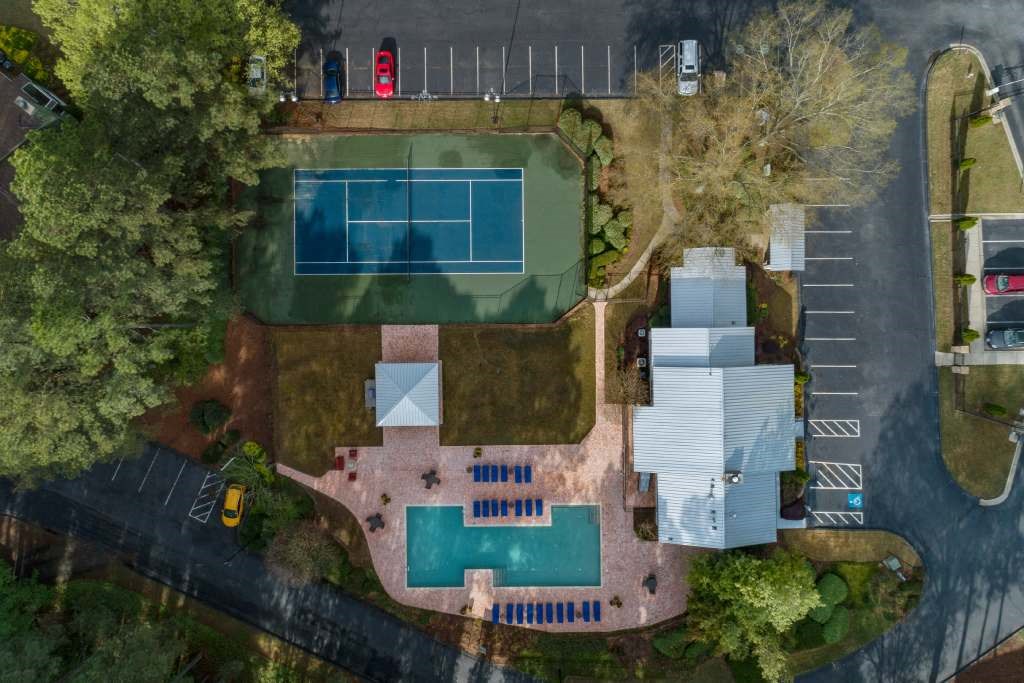 an aerial view of a house with a tennis court and tennis court