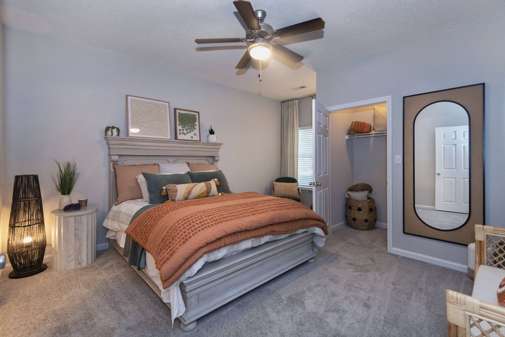 a bedroom with a bed and a ceiling fan at Whitehall Estate apartments in Charlotte NC