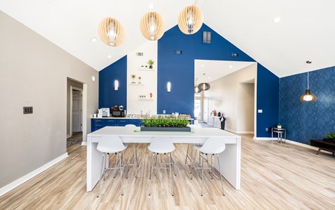 A modern kitchen with a dining table and chairs.
