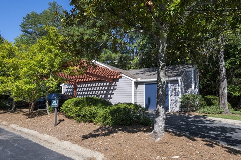 a car parked in a Car Wash amenity at Wynnwood Vinings apartments under a wooden shade
