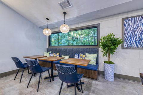 A dining room with a table and chairs.