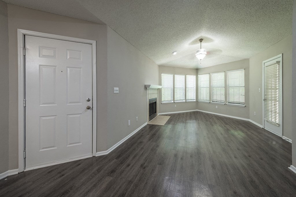 an empty living room with a fireplace at eclipse apartments duluth ga