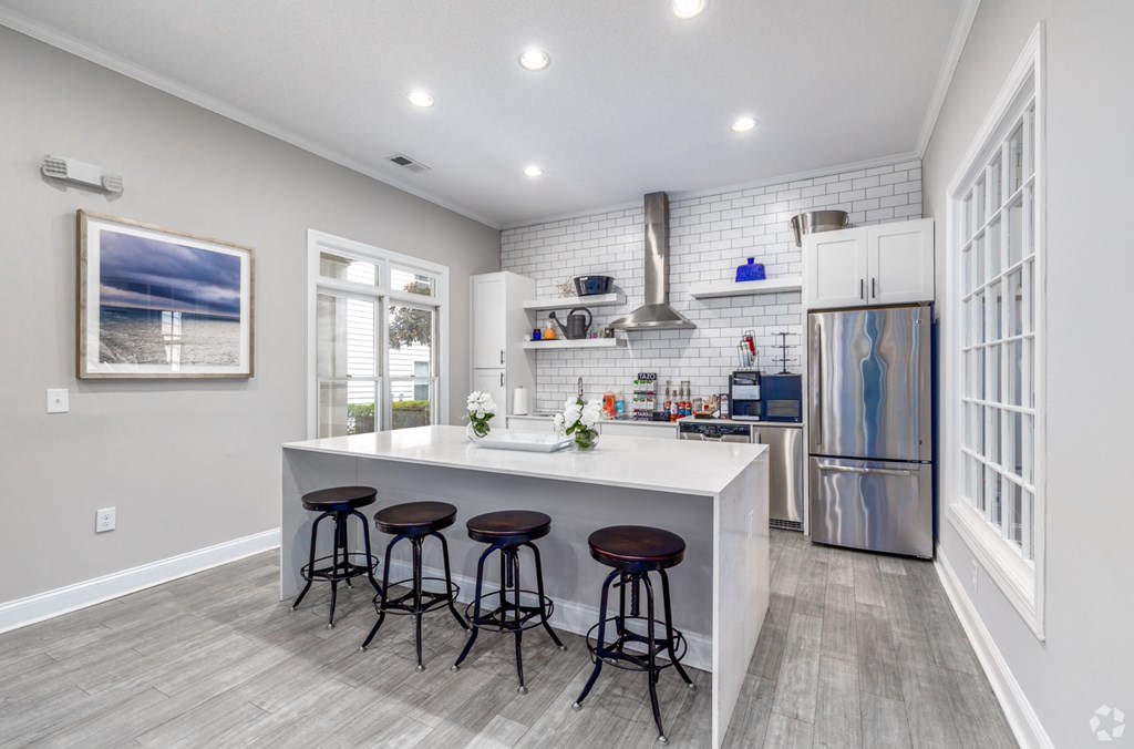 A kitchen with a white countertop and a refrigerator.