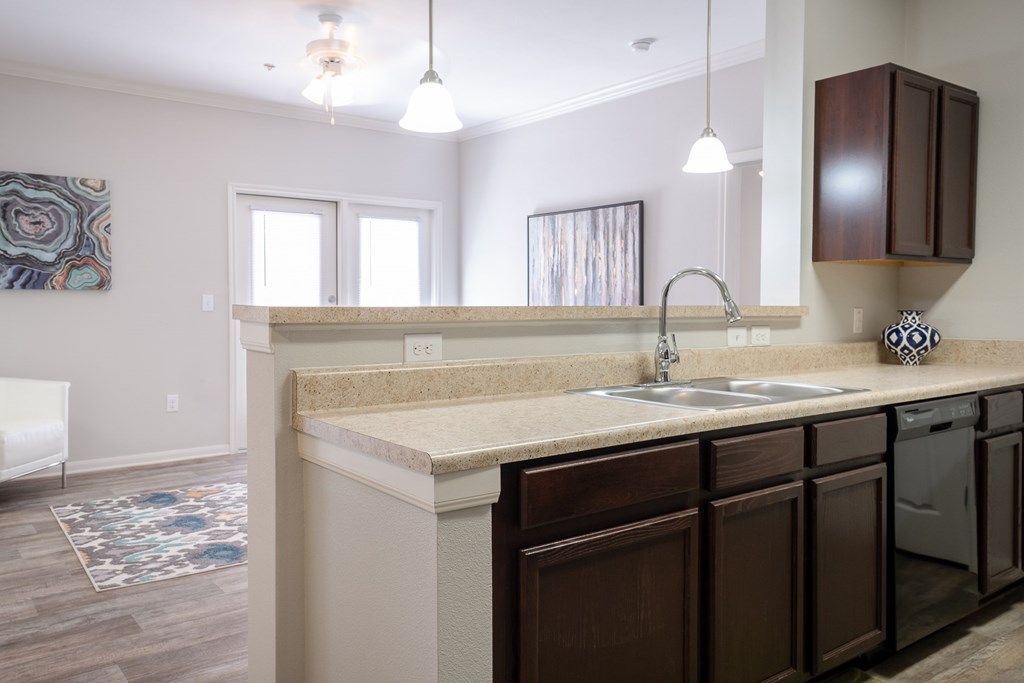 A kitchen with brown cabinets and a white countertop.