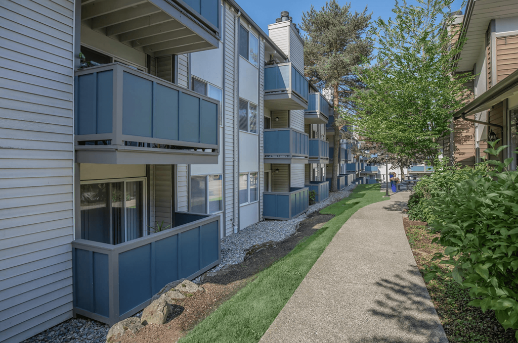 a shaded walkway between two buildings at Foster Creek apartments