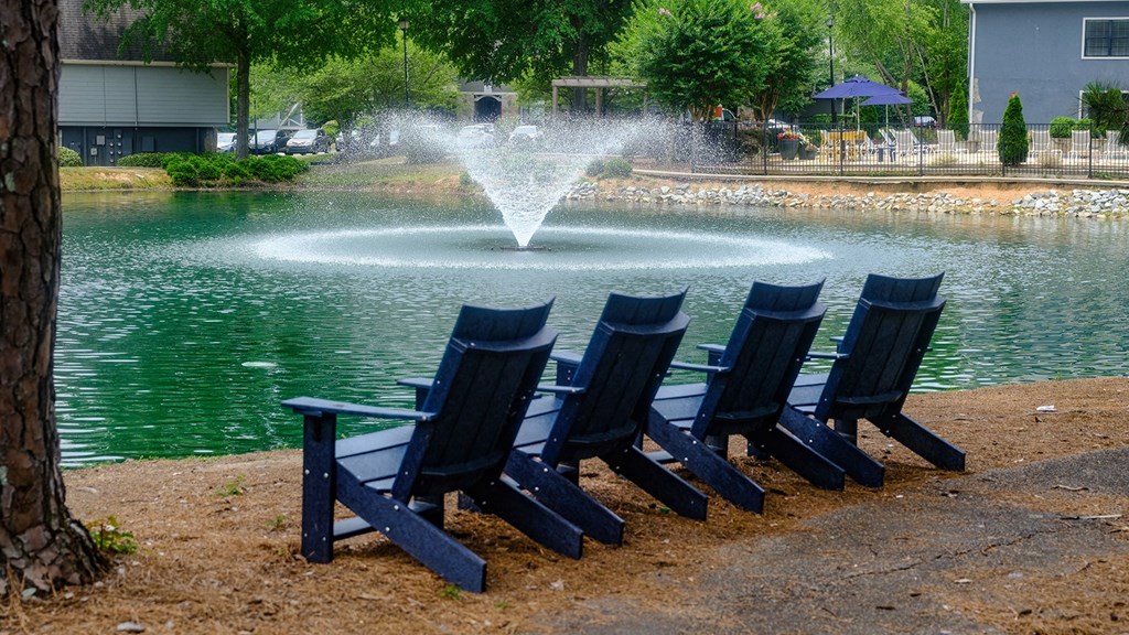 Scenic view of Amberlake Village apartments' walking trails and sitting overlooking the lake