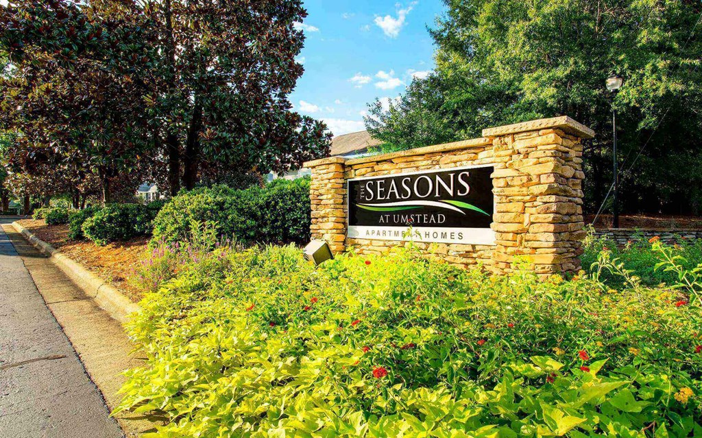 Entrance sign to Seasons at Umstead at the entrance of an apartment community