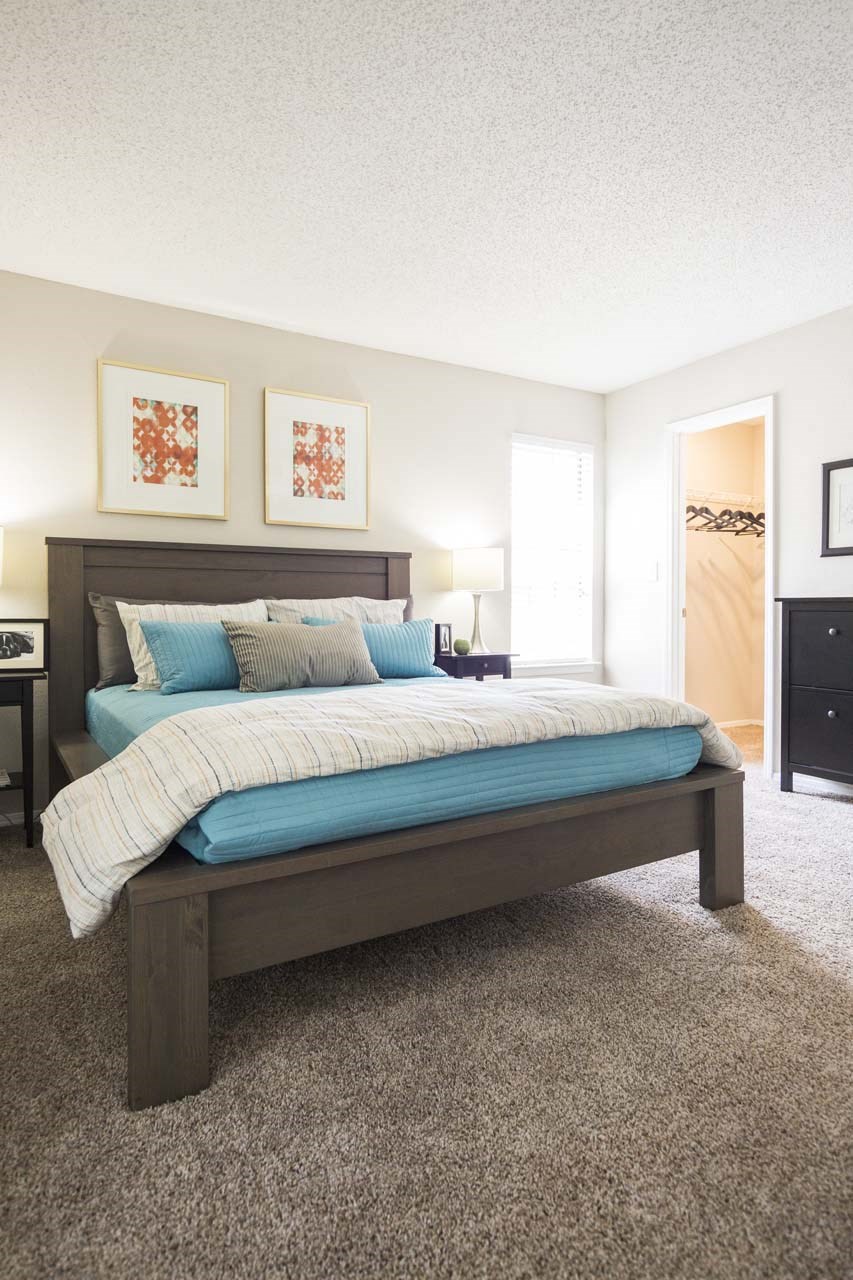 a bedroom with a bed and a closet