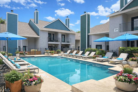 Dog-Friendly Apartments in Churchill Estates, TX - Apex Apartments - Swimming Pool With Lounge Chairs, Blue Umbrellas, Colorful Planters, And Surrounding Residential Buildings.