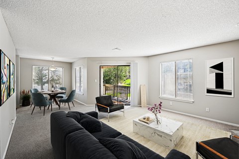 A living room with a grey couch and a coffee table.