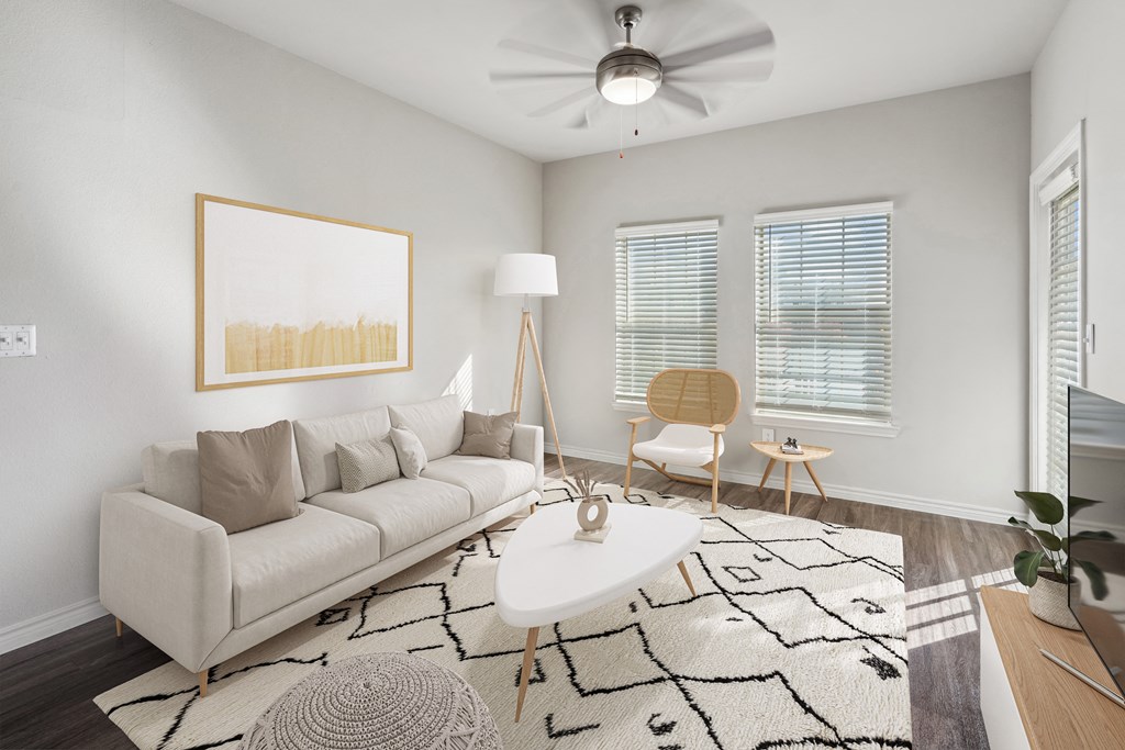 a living room with a white couch and a white coffee table
