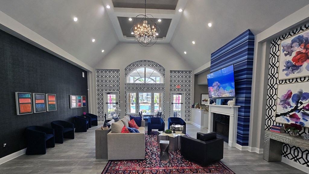 a living room with couches and chairs and a fireplace