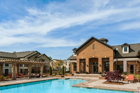 A large house with a pool in front.