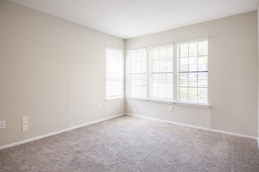 One Bedroom Apartments in Duluth, GA - The Eclipse - Bedroom with Plush Carpet Flooring and Windows with Blinds