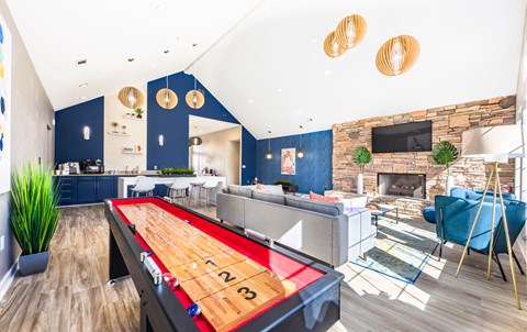 a living room with a ping pong table and a fireplace