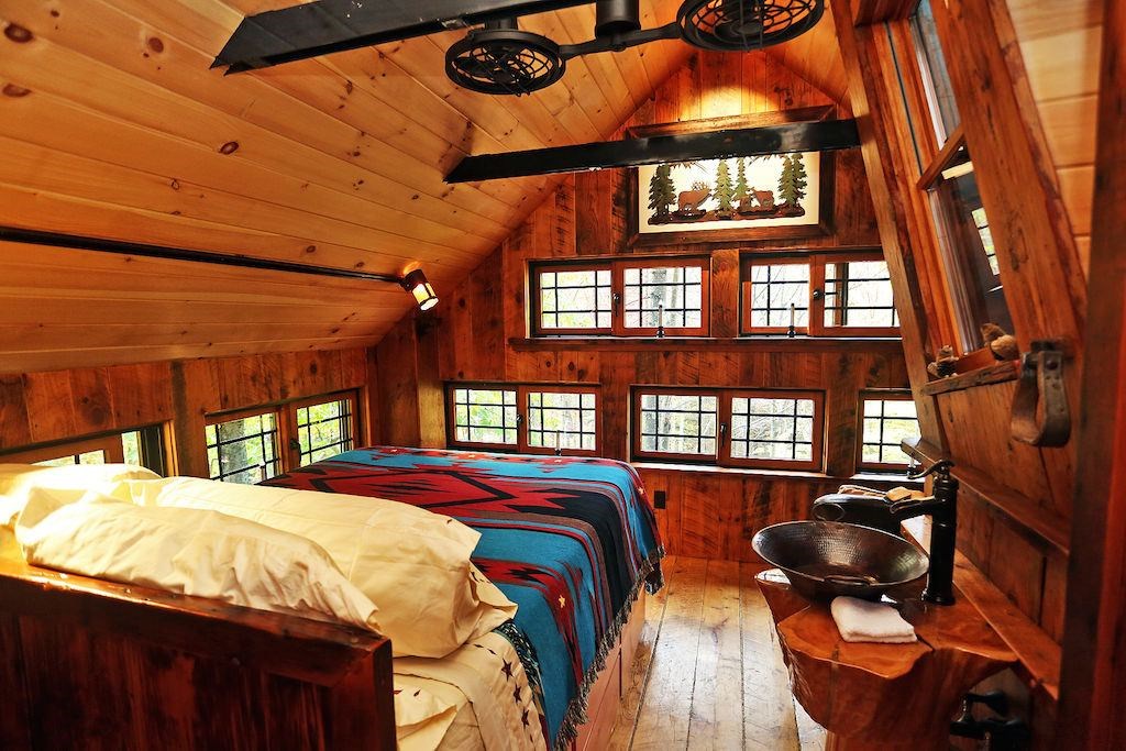 a bedroom with two beds in a wooden cabin