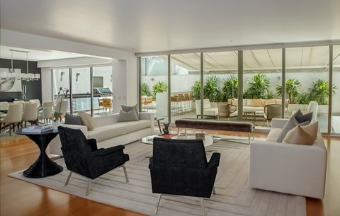 A modern living room with black and white furniture.