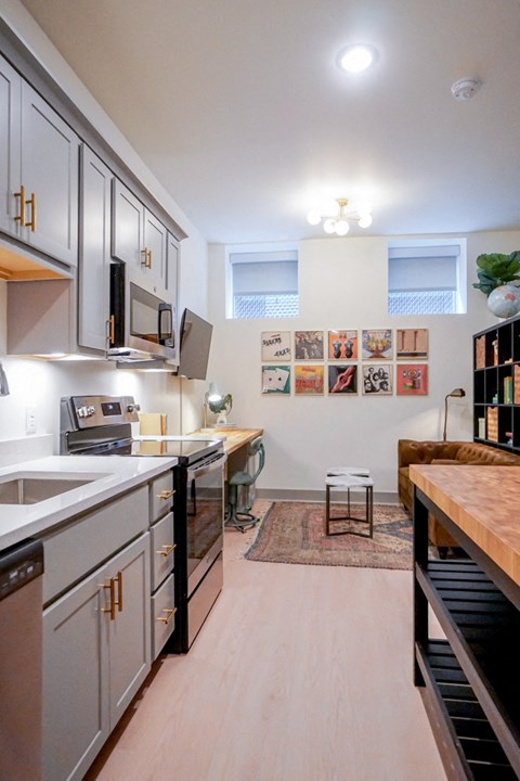 a kitchen with white cabinets and a counter top