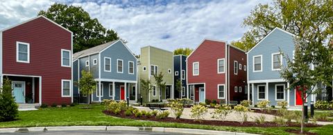 A row of houses with different colored exteriors.