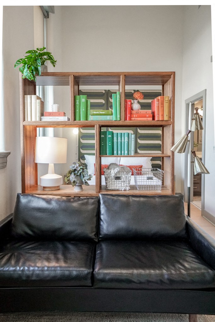 bookshelf room divider between living room and bedroom in apartment at Myers Medical Lofts