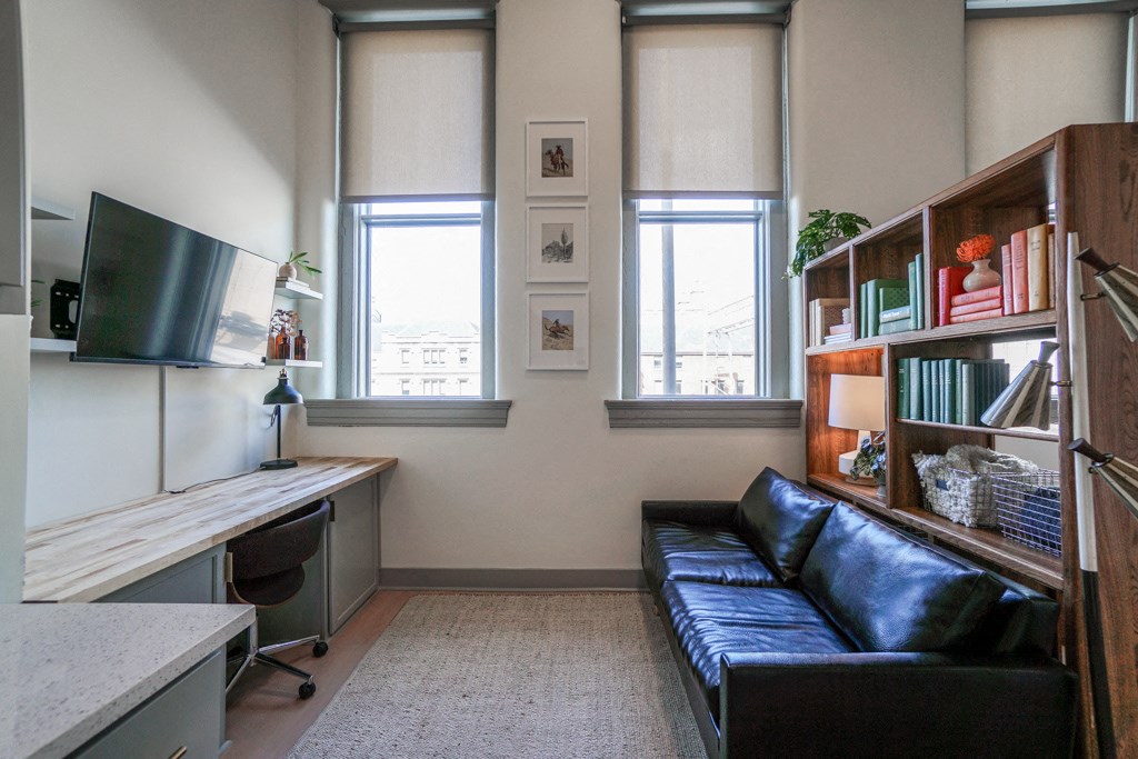 living room area with 2 large windows in apartment at Myers Medical Lofts