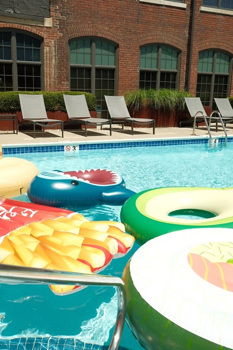 a swimming pool with a bunch of inflatable toys in it