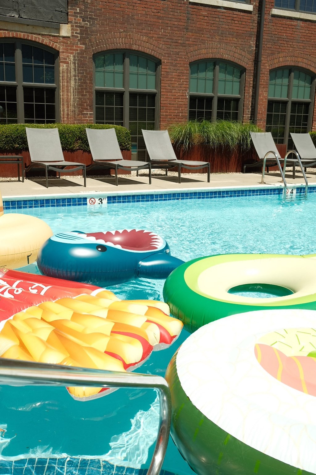 a swimming pool with a bunch of inflatable toys in it