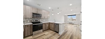 A kitchen with wooden cabinets and a white counter top.
