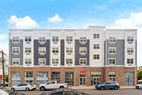 an image of a building with cars parked in front of it