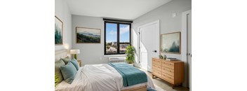 a bedroom with a bed and a large window