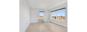 A room with a window overlooking a cityscape.