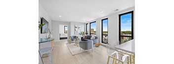 a living room with white walls and hardwood floors