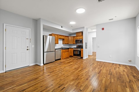 A kitchen with wooden floors and white walls.