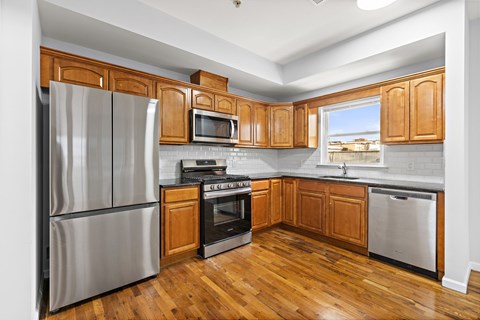 A kitchen with wooden cabinets and stainless steel appliances.