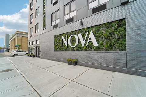 A building with a green wall and the word "NOVA" on it.