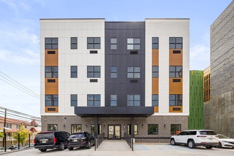 the front of a building with cars parked in front of it
