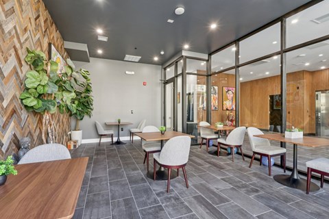 A modern dining area with wooden tables and chairs.