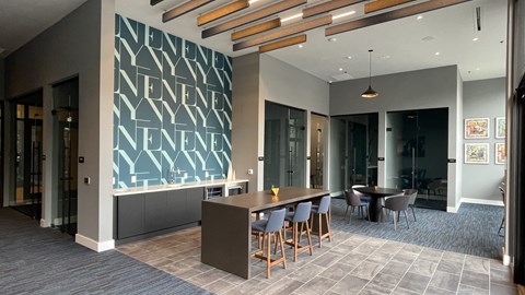 A modern dining area with a wooden table and chairs.
