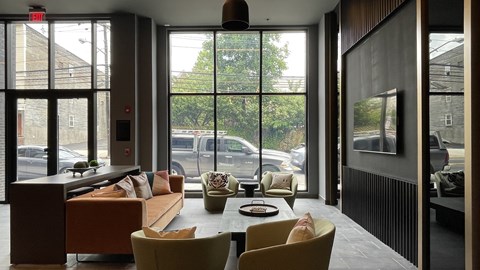 A modern living room with a couch, chairs, and a coffee table.