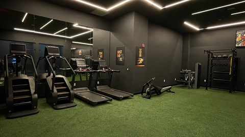 A gym with treadmills, exercise bikes, and other equipment.