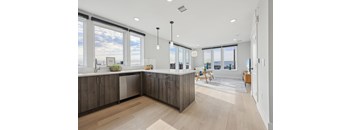 A modern kitchen with wooden cabinets and a large island.