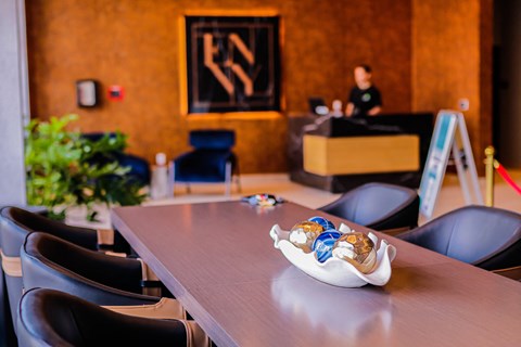 a table with chairs and a bowl of figurines on it